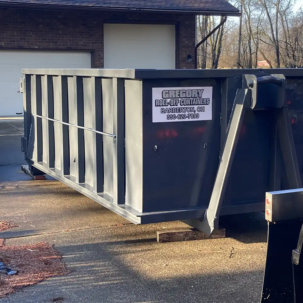 A gray 12-yard dumpster rental in front of a home in Akron, Ohio.