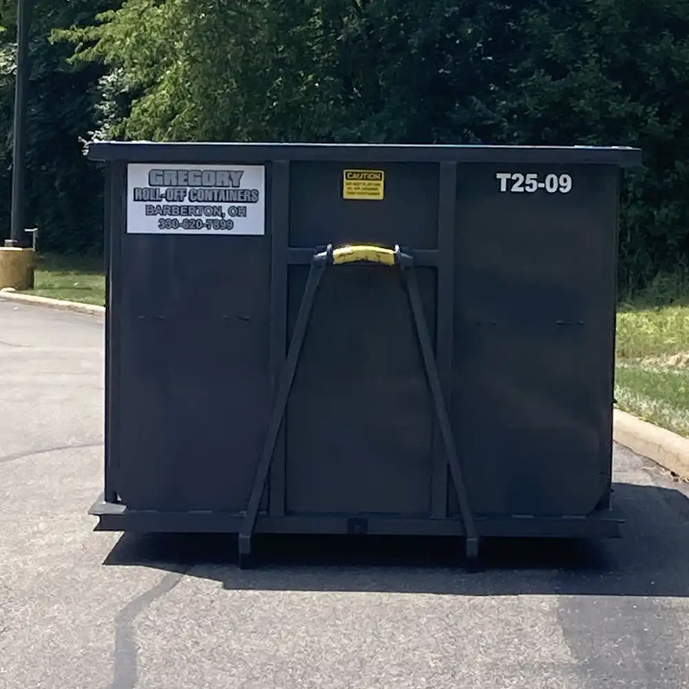 A gray 25-yard dumpster rental in a parking lot in Akron, Ohio.