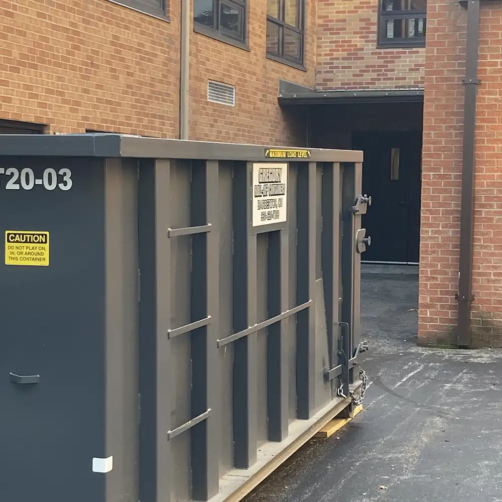 A commercial dumpster rental in front of a school building in Akron, Ohio.