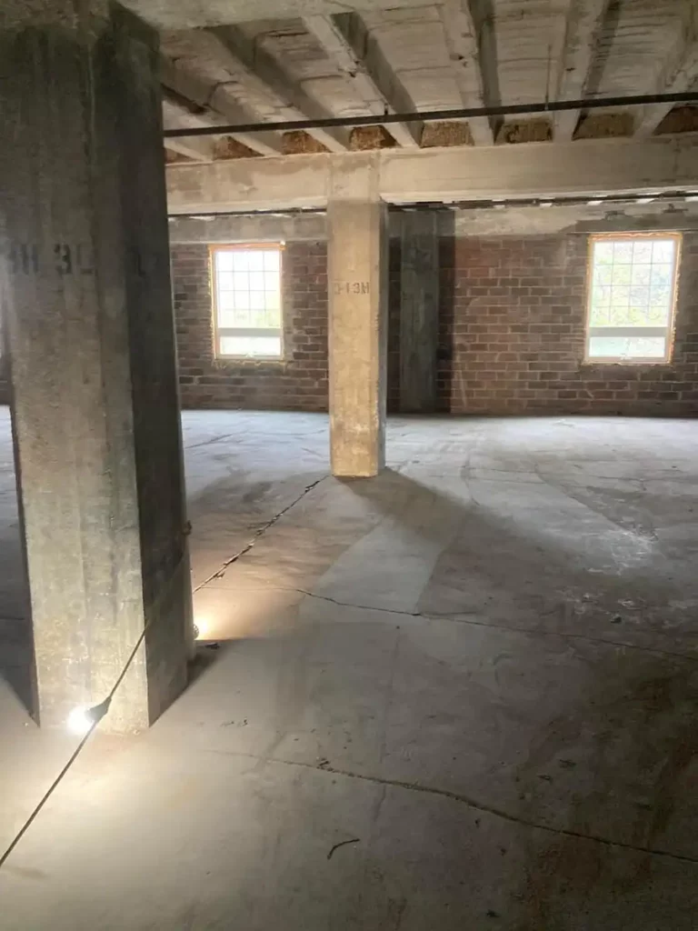 An empty room with concrete floors and pillars, in need of clean-out services in Akron.